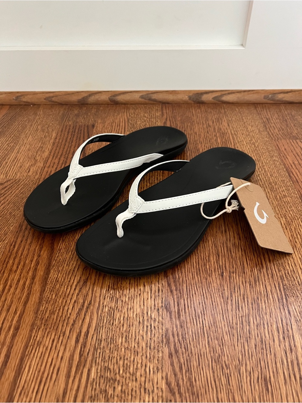 OluKai Ho’opio Malia Women's Black Flip Flops with White Thong Straps